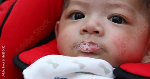 baby playful saliva bubble in mouth photo