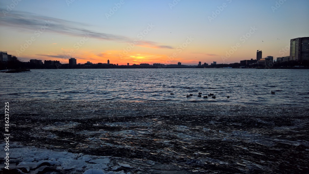 Hundreds of ice shards pile along the bank of the Charles River in Boston, MA at sunset in early winter