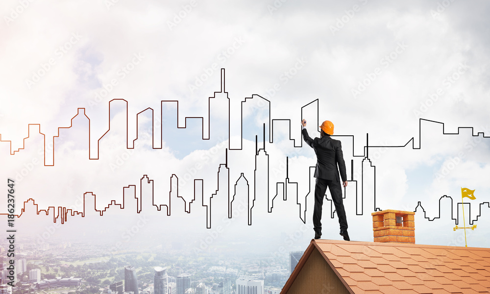Man architect draw silhouette of modern city on blue sky. Mixed media Man architect draw silhouette of modern city on blue sky. Mixed media