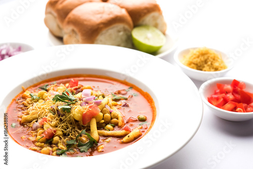 Misal Pav or misalpav, Misal Pav with Farsan. Traditional Indian spicy dish made with moth beans (match) and served with farina and bread
 photo