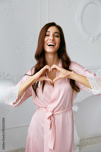 Love. Beautiful Female Model Showing Heart With Hands.