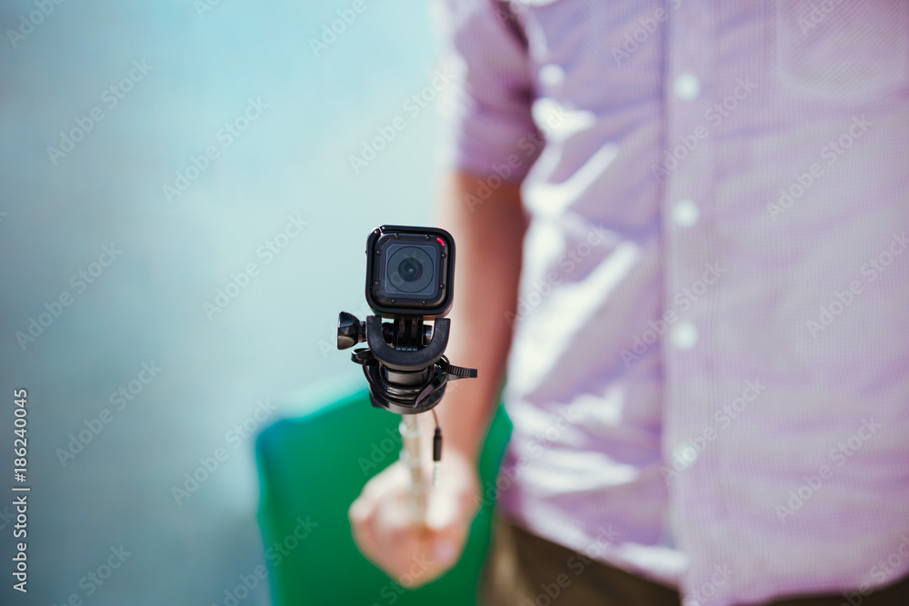 Man holding adventure camera close up on selfie stick Stock Photo | Adobe  Stock