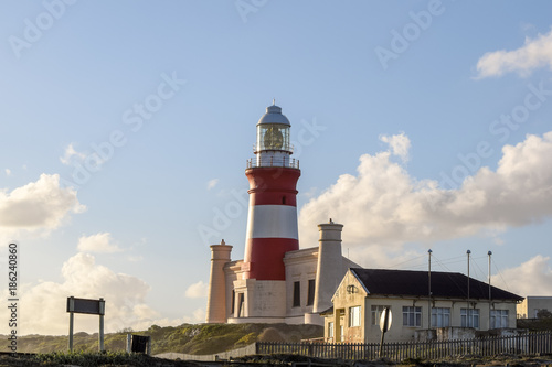 Beautiful view of Cape Agulhas Lighthouse. The lighthouse is located at the southernmost point of Africa and at the same time lies at 20 degrees east latitude exactly. Popular tourist destination.