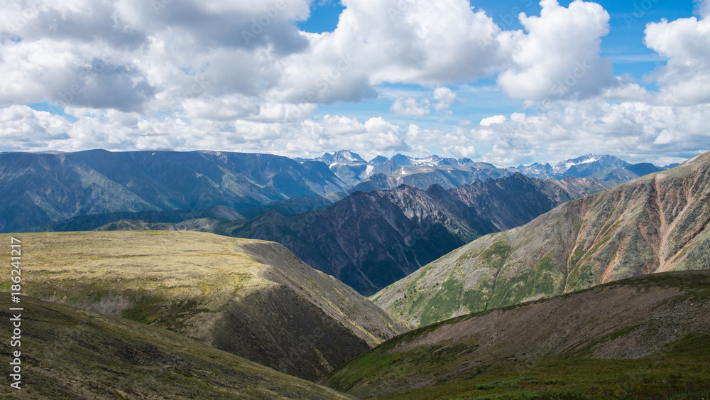 Summer Landscape of Eastern Sayan Mountains, scenic voew with cloudy sky. Russia, Siberia.