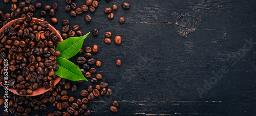 Coffee beans. On a wooden background. Top view. Copy space.