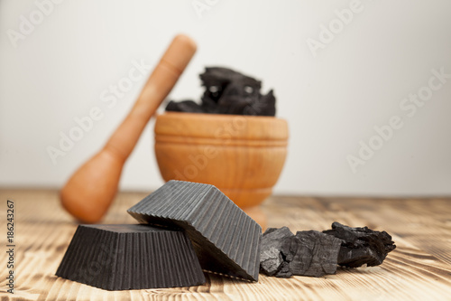 two hand made black soap from activated carbon on white background photo