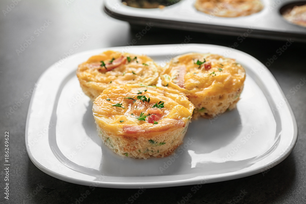 Plate with tasty egg muffins on table Plate with tasty egg muffins on table