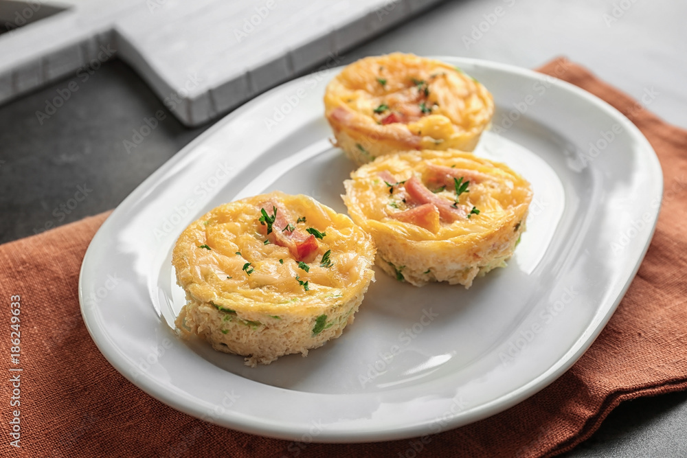 Plate with tasty egg muffins on table Plate with tasty egg muffins on table