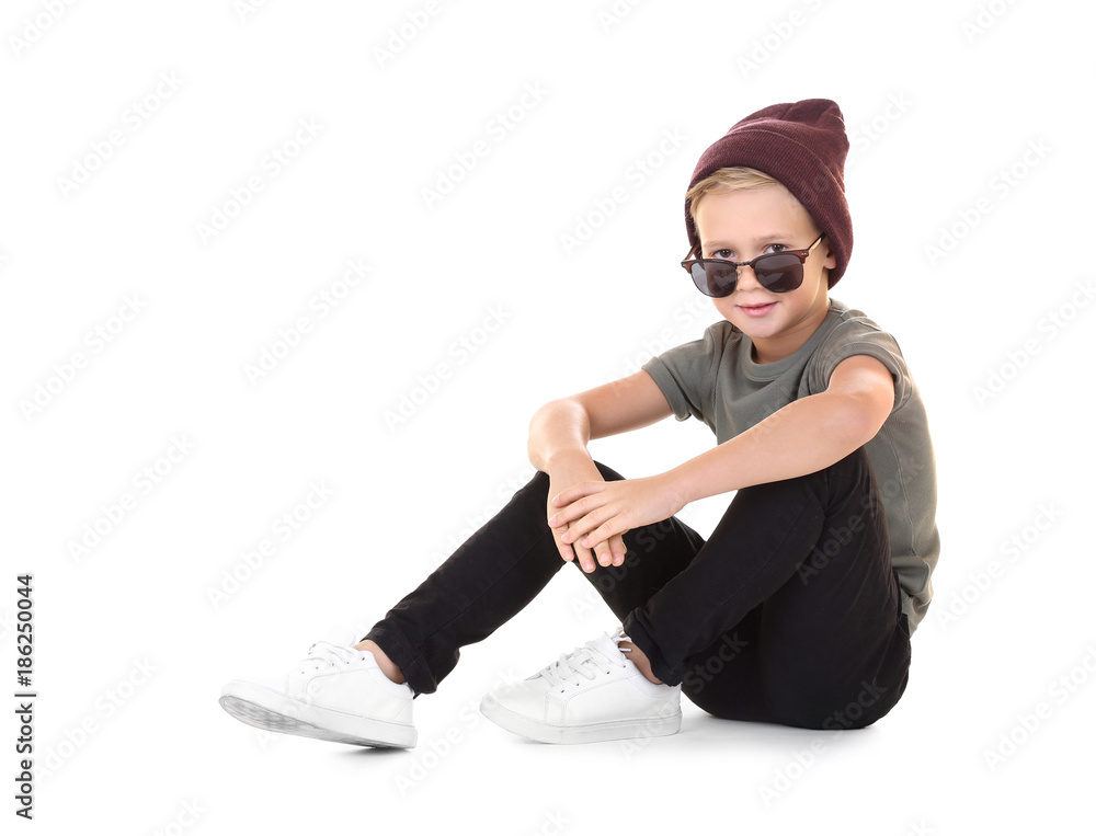 Cute fashionable boy sitting on white background Cute fashionable boy sitting on white background