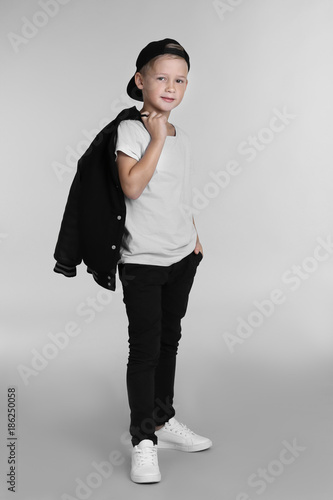 Cute fashionable boy on lig...