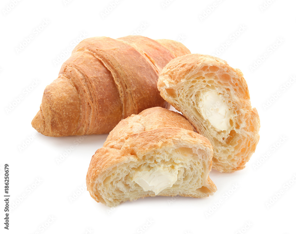 Yummy fresh croissant with cream on white background