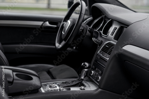 Luxury car interior. Steering wheel, shift lever and dashboard. © gorynvd