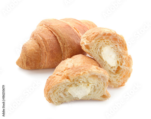 Yummy fresh croissant with cream on white background