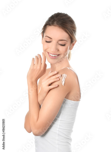 Young woman applying body c...
