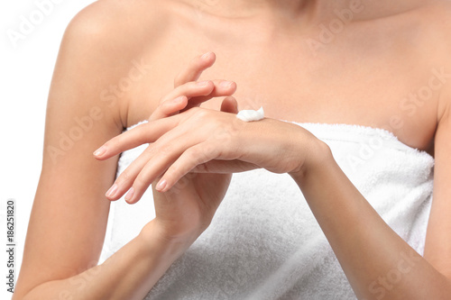 Young woman applying hand c...