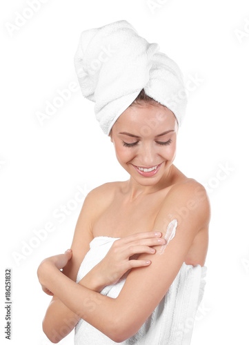 Young woman applying body c...