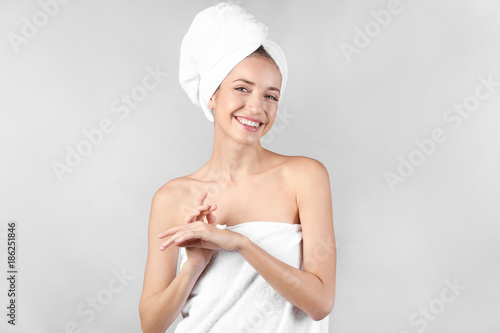 Young woman applying hand c...