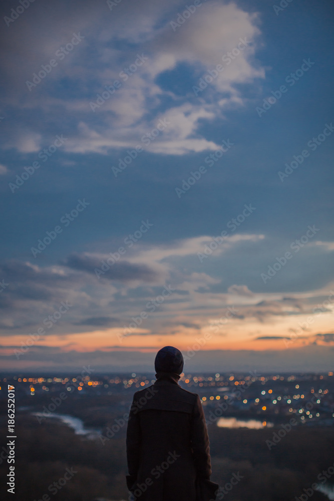 Man watching sunset from the hill Man watching sunset from the hill