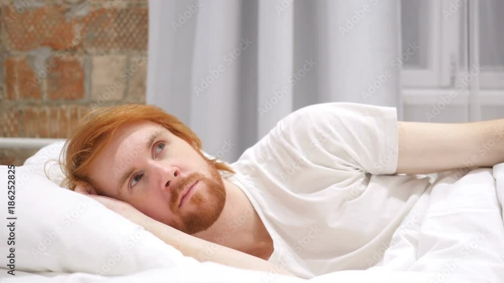 Thinking, Pensive Man Lying on Side and Dreaming while in Bed Thinking, Pensive Man Lying on Side and Dreaming while in Bed