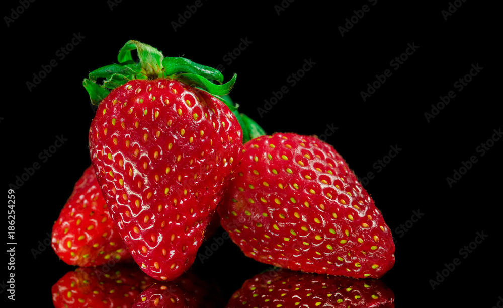 custom made wallpaper toronto digitalRed Strawberries with green leafs, on top of a reflective glass surface, and black background, isolated.