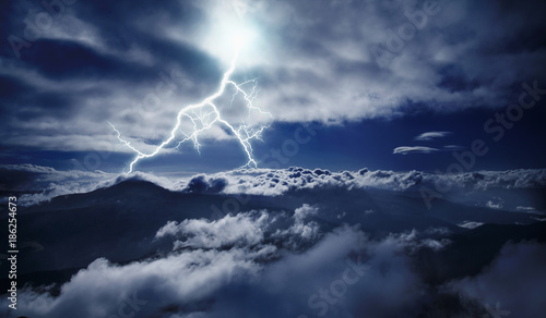 Dramatic scene of thunderstorm with lightning in dark stormy sky in mountains Carpathian, Ukraine. © zwiebackesser