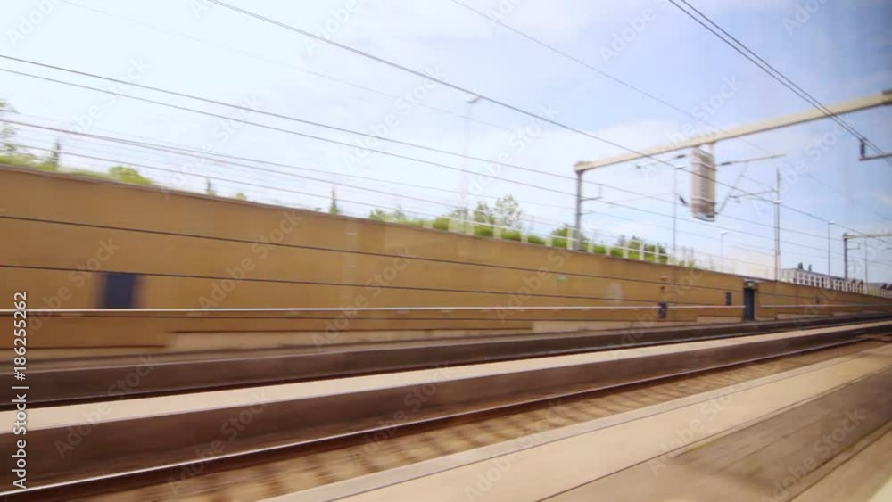 View from the window moving train along railway platform. Train railroad. Country trip on train View from the window moving train along railway platform. Train railroad. Country trip on train