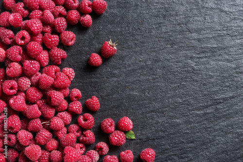 Sweet raspberry on black slate. Copy space. Top view. High resolution product.