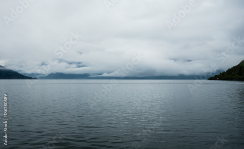 Low clouds over water in Hardangerfjord, Norway.