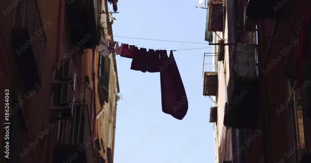 NAPLES, ITALY – JULY 2016 : Video shot of street in downtown Naples on a sunny day with drying clothes in view NAPLES, ITALY – JULY 2016 : Video shot of street in downtown Naples on a sunny day with drying clothes in view