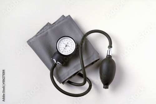 Blood Pressure Cuff on White Background.  Also known as a sphygmomanometer it is used to measure the blood pressure of patients in a medical environment. photo