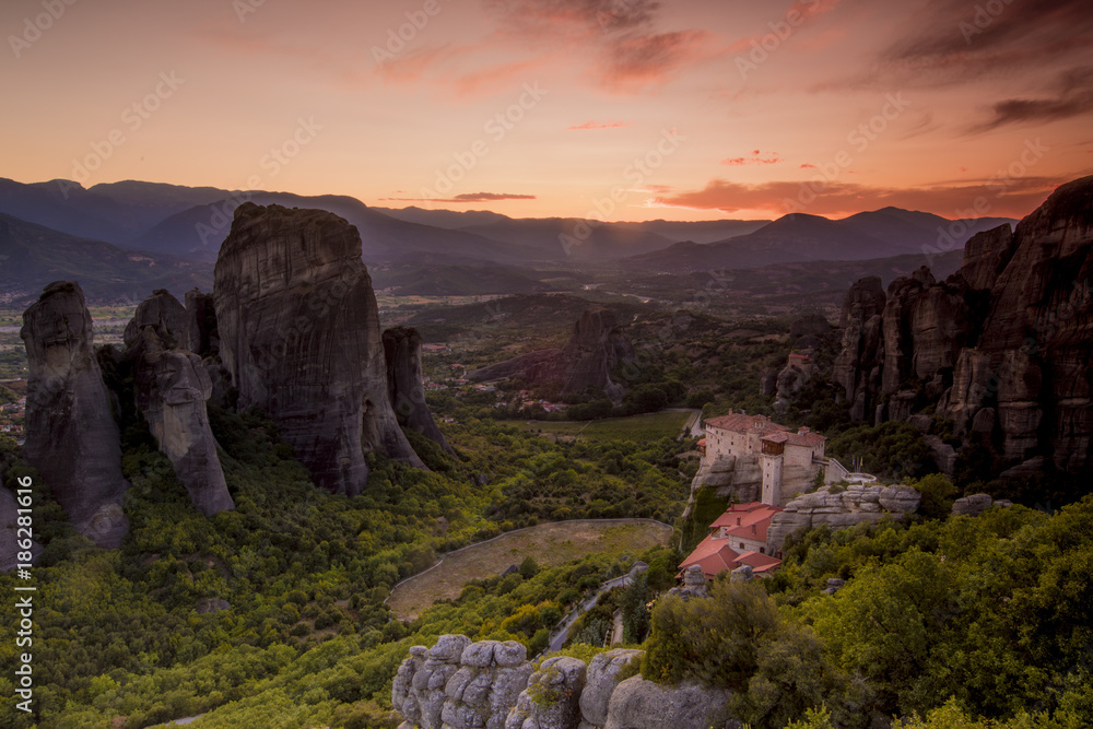 Amazing view of the Meteora site in Greece at sunset with one  monestry
