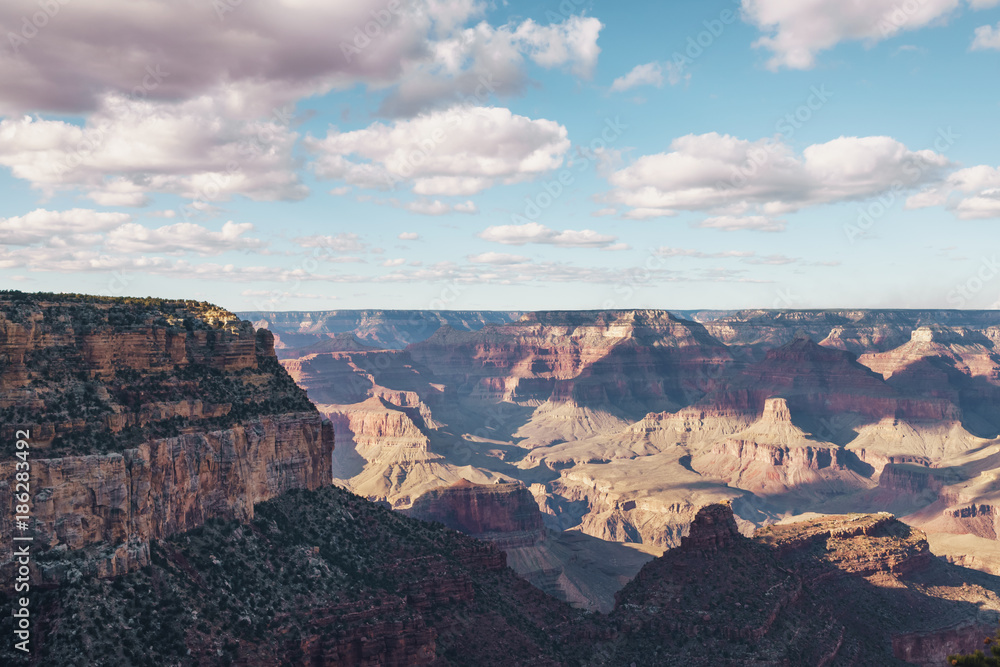 view from South Rim of Grand Canyon in sunny autumn day with white clouds