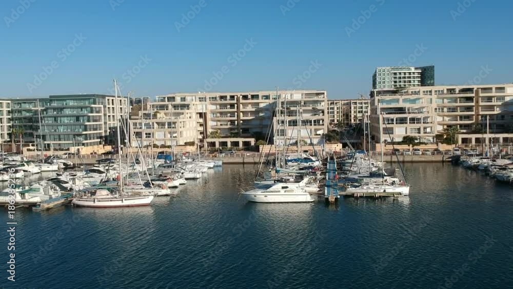 Herzliya Marina with yachts anchored under a luxury residential complex Herzliya Marina with yachts anchored under a luxury residential complex