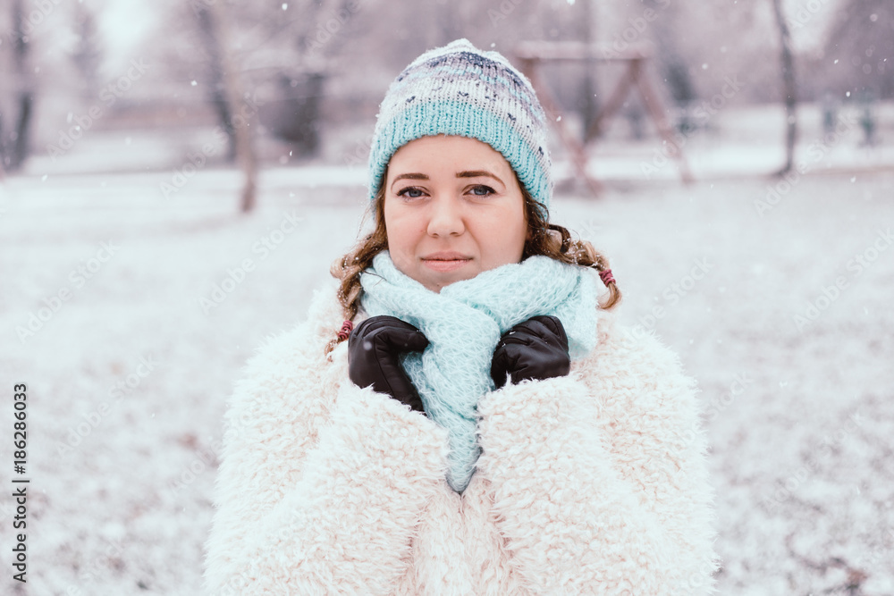 Smiling young woman in snowing outdoor. Smiling young woman in snowing outdoor.