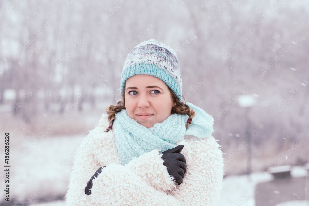 Smiling young woman in snowing outdoor. Smiling young woman in snowing outdoor.