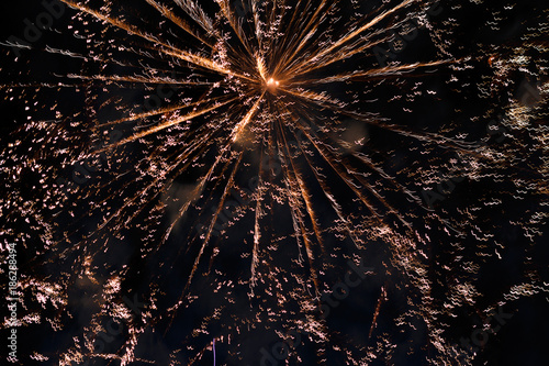 Salute in the night sky. Bright texture of festive fireworks. Abstract holiday background with various colors fireworks light. New Year's, Christmas lights in the sky, colorful lights.