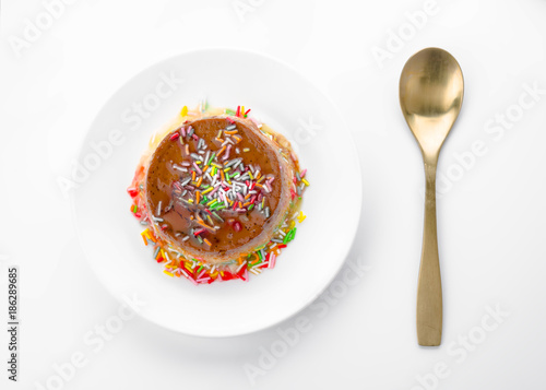 egg custard with caramel shavings isolated on white