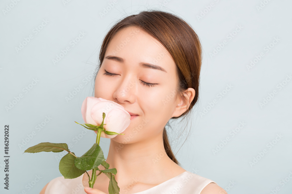Portrait of a beautiful woman with pink rose. Portrait of a beautiful woman with pink rose.