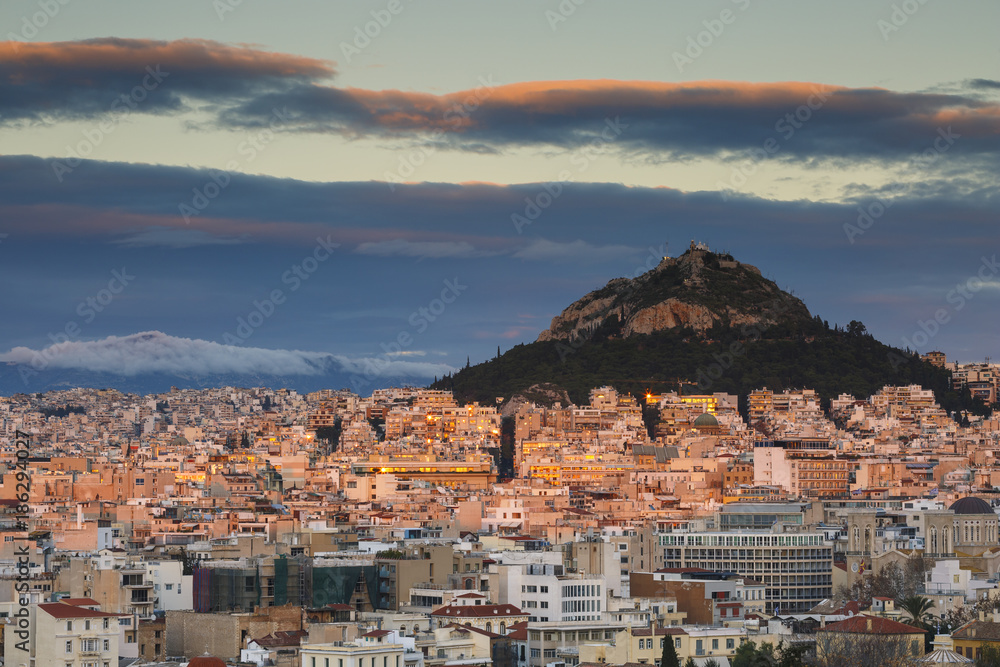 View of Athens and Lycabettus Hill from Areopagus hill at sunset, Greece. 
