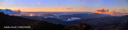 Panoramic view of Cerro de la Muerte Costa Rica with a volcano in the clouds, illuminated by the setting sun. Mountain landascape. Los Quetzales National Park Nature Reserve. Costa rica.