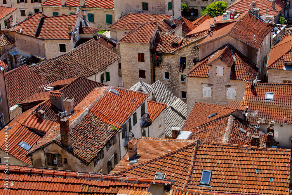 Old town near Kotor  bay with buildings with orange piles roofs