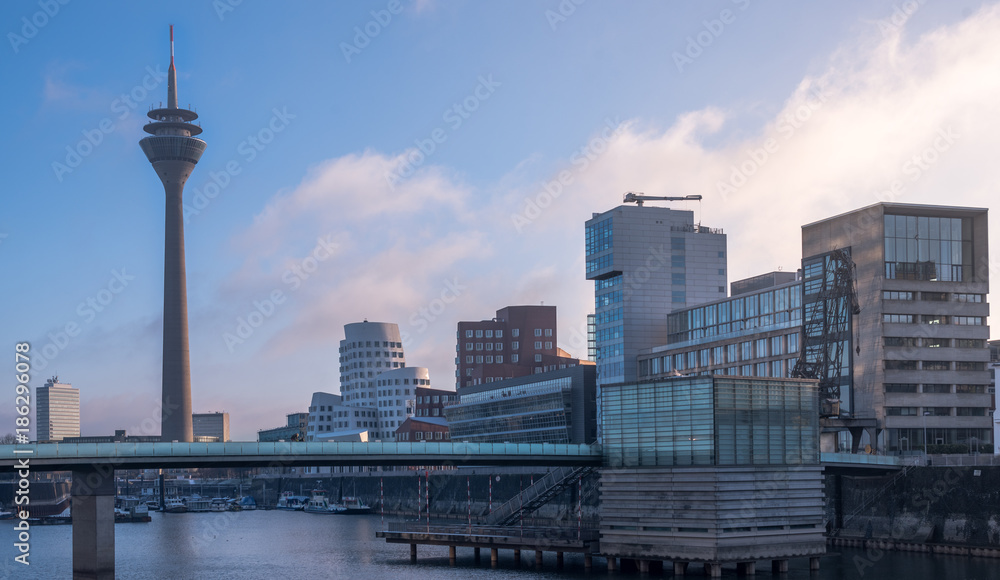 Dusseldorf media harbor skyline at sunrise. Modern and futuristic buildings by the water in Europe