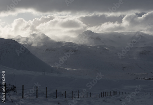 Light on snowy mountain peaks in winter remote Iceland