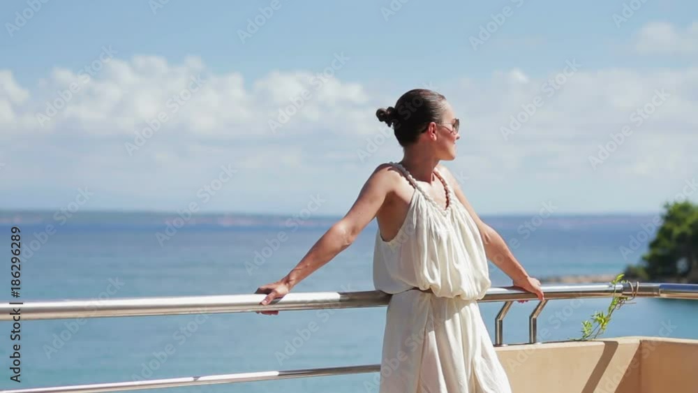 Young happy woman relaxing at luxury hotel terrace
Young happy woman relaxing at luxury hotel terrace