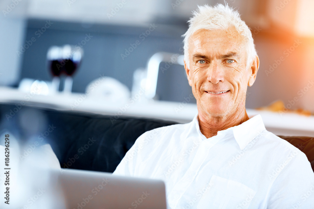 Man working on laptop at home Man working on laptop at home