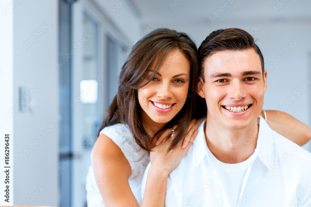 Smiling merry couple looking at camera Smiling merry couple looking at camera