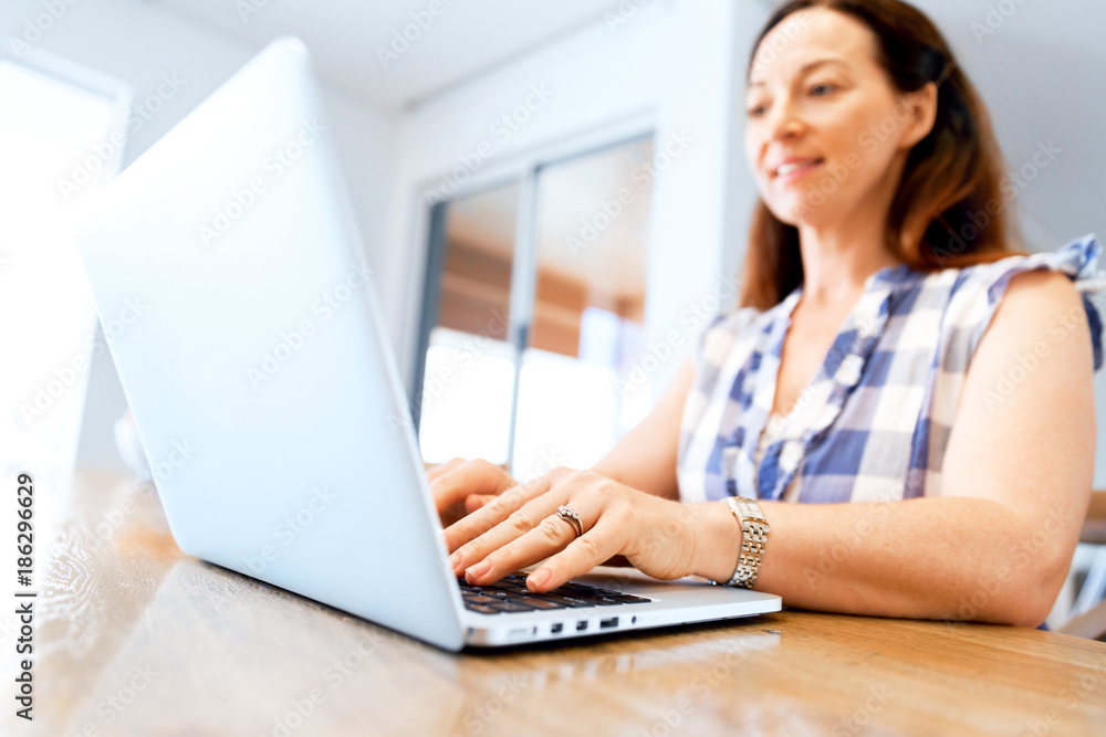 Mature beautiful woman working on her laptop Mature beautiful woman working on her laptop