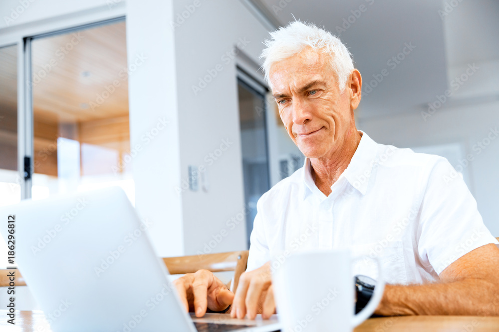 Man working on laptop at home