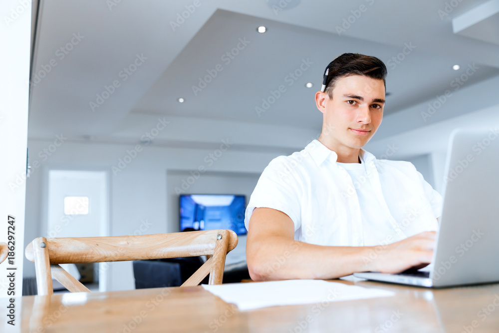 Man working on laptop at home Man working on laptop at home