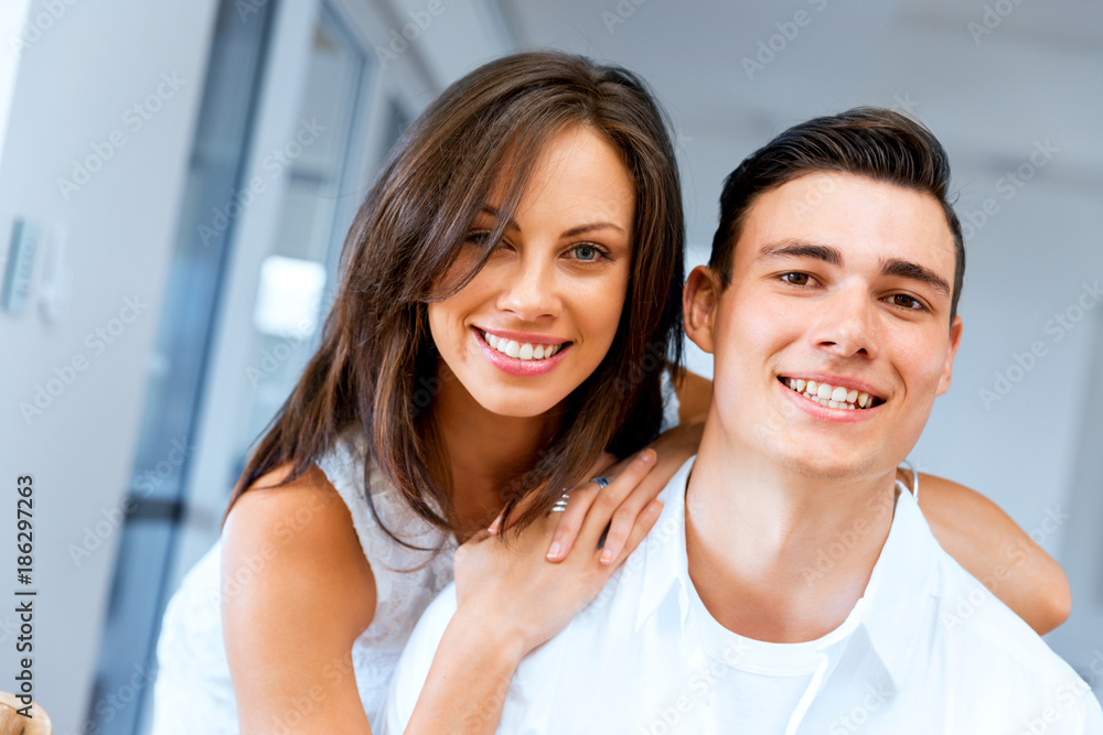 Smiling merry couple looking at camera Smiling merry couple looking at camera